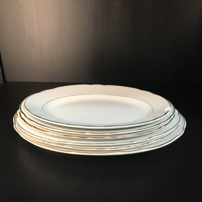 Vintage set of oval serving platters with gold edges