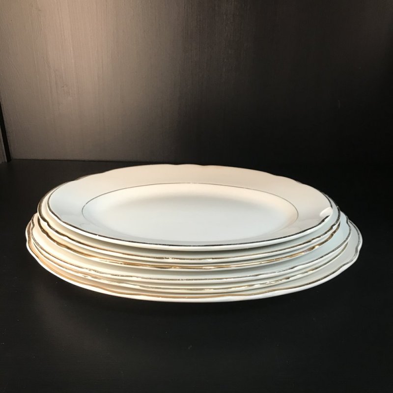 Vintage set of oval serving platters with gold edges