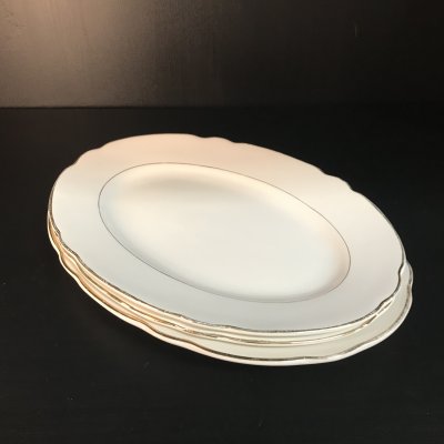 Vintage set of oval serving platters with gold edges