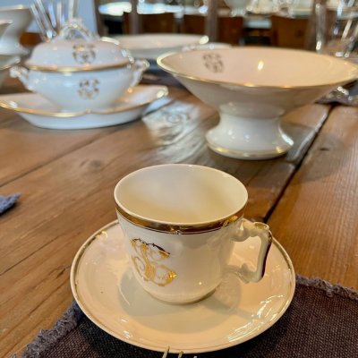 Vintage table set with gold lines and monogram 
