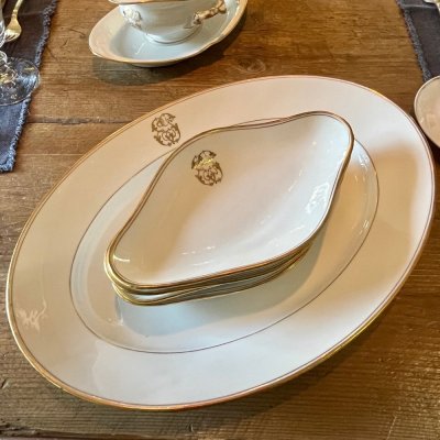Vintage table set with gold lines and monogram 